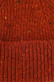 Close-up view of Uskees 4003 'burnt orange' speckled donegal wool hat, showing the texture of the natural Scottish merino wool.