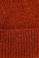 Close-up view of Uskees 4003 'burnt orange' speckled donegal wool hat, showing the texture of the natural Scottish merino wool.