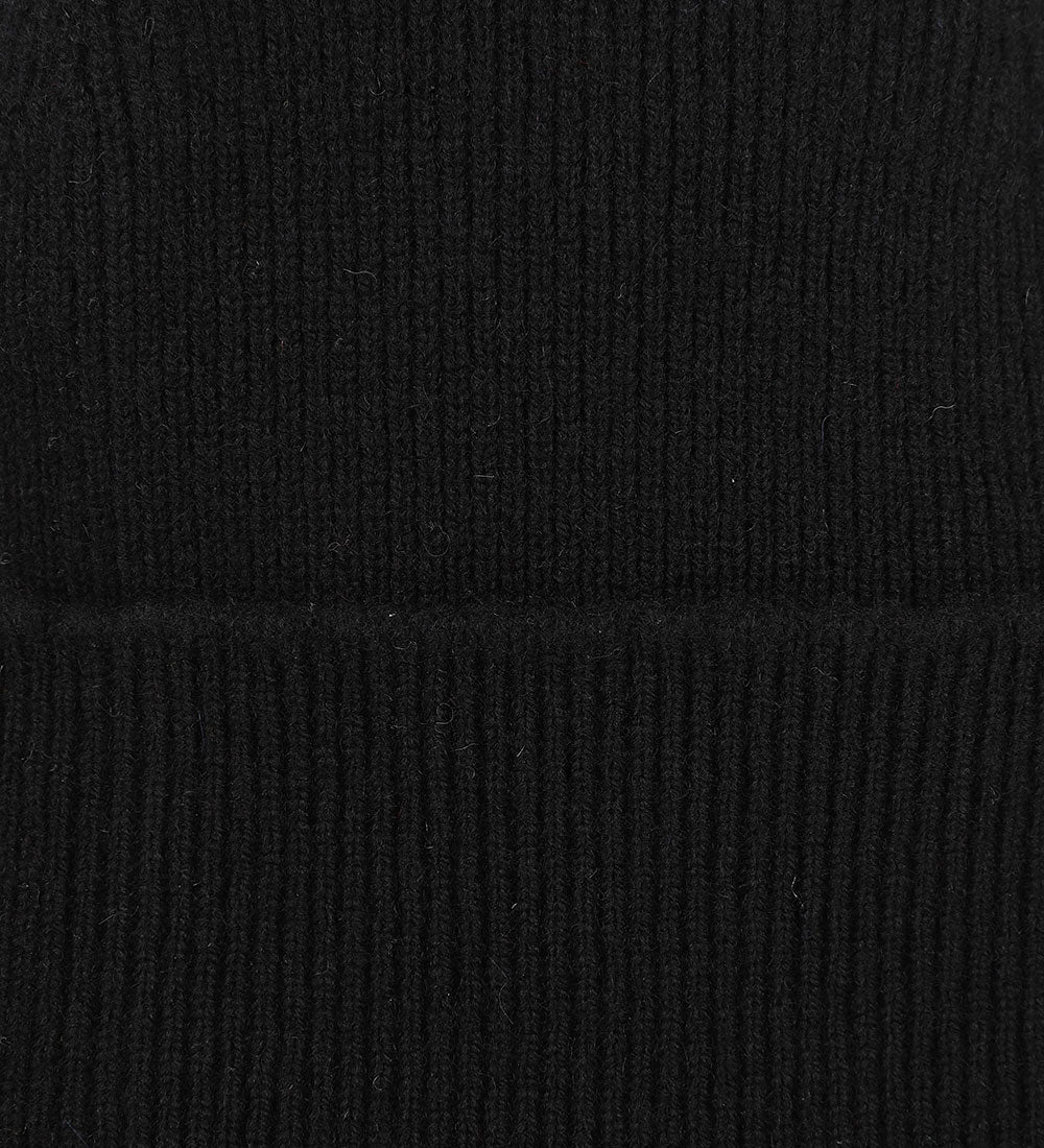 Close-up view of Uskees 4004 black wool hat, showing the texture of the natural lambswool.