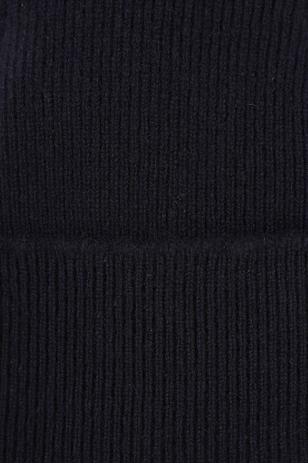 Close-up view of Uskees 4004 navy-blue wool hat, showing the texture of the natural lambswool.