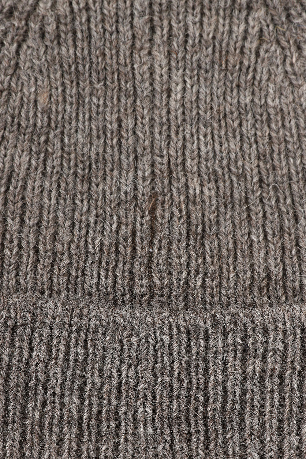 Close-up view of Uskees 4005 'rye' greyish coloured wool hat, showing the texture of the Bluefaced Leicester and Masham wool blend.