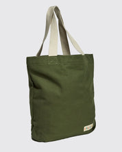 Slightly angled front view of Uskees #4009 'coriander' coloured canvas tote bag, showing double webbing straps and Uskees woven logo.