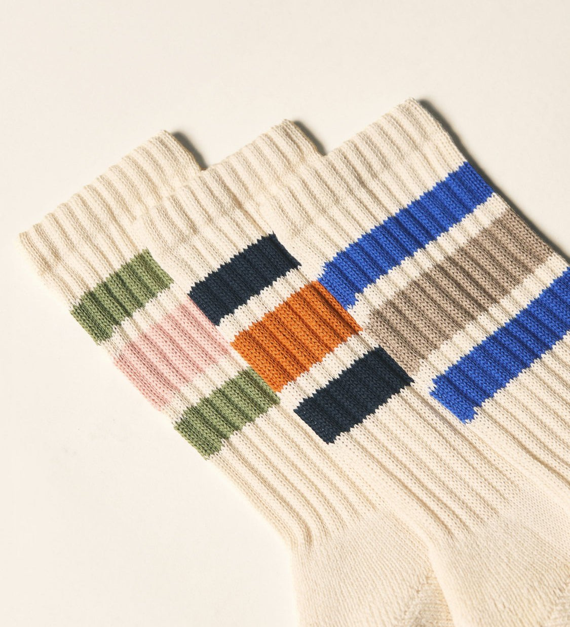 Closer view of the upper leg of the full range of Uskees 4011 socks, with a focus on the multicoloured 'college stripes'.