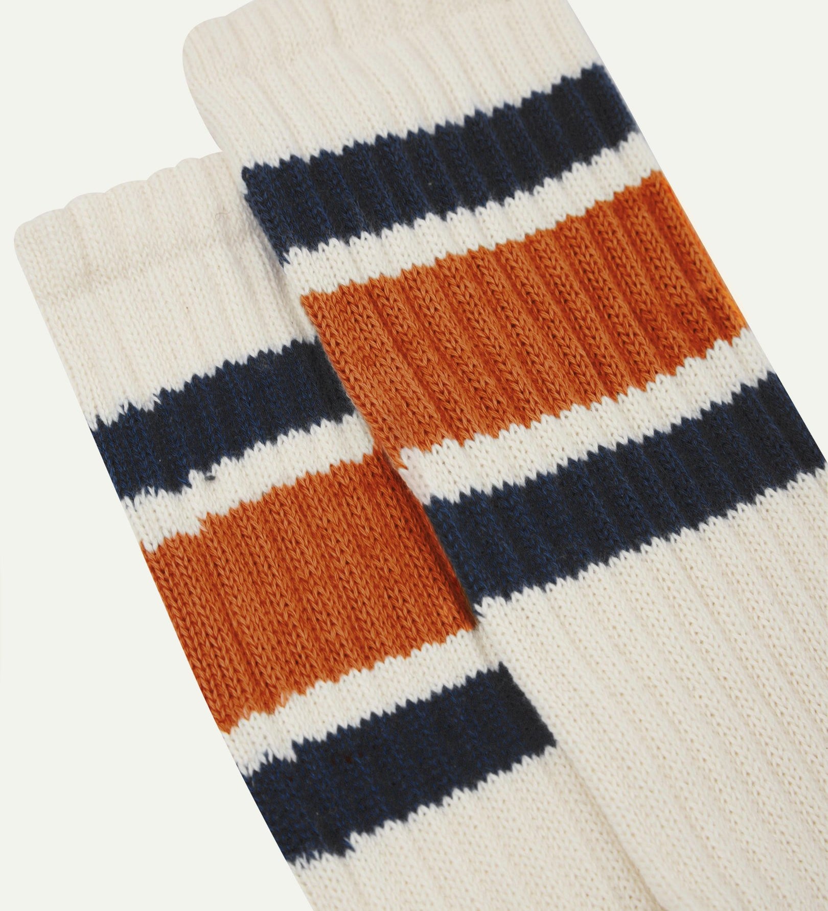 Closer view of the upper leg of a pair of Uskees 4011 socks, showing the 'college stripes' comprising of two midnight blue and one thicker gold-orange band.