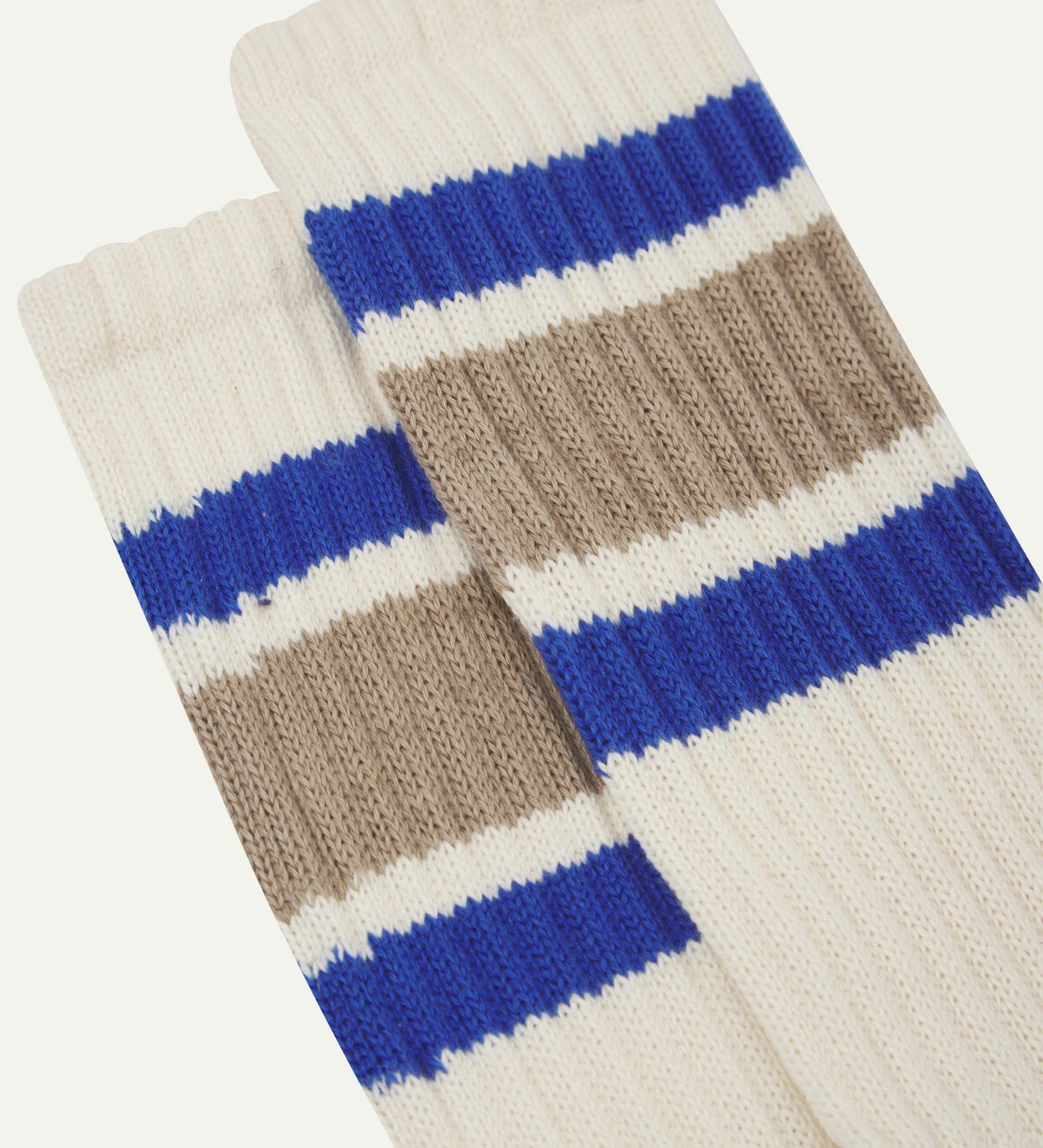 Closer view of the upper leg of a pair of Uskees 4011 socks, showing the 'college stripes' comprising of two ultra blue and one thicker khaki band.