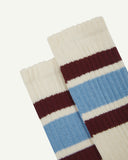Close up of a pair of Uskees men's white sport socks showing the colourful stripes  on a white background.