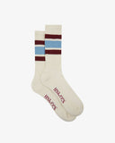 Pair of Uskees men's white sport socks with colourful stripes and 'USKEES' branding on the sole on a white background