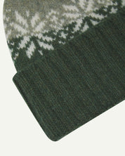Close-up of the coriander snowflake hat from Uskees, clearly showing the ribbing of the adjustable cuff and texture of the natural Scottish lambswool.