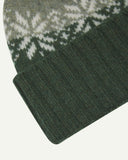 Close-up of the coriander snowflake hat from Uskees, clearly showing the ribbing of the adjustable cuff and texture of the natural Scottish lambswool.