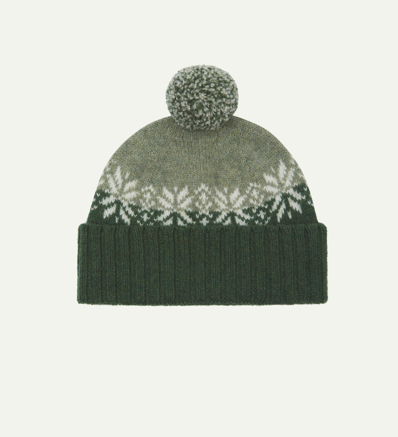 Front view of Uskees 4012 'coriander' lambswool snowflake hat, with a clear view of the coriander, pale green and white colourway, snowflake motif and bobble.