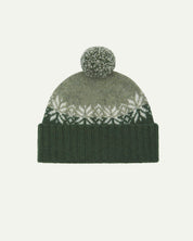 Front view of Uskees 4012 'coriander' lambswool snowflake hat, with a clear view of the coriander, pale green and white colourway, snowflake motif and bobble.