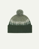 Front view of Uskees 4012 'coriander' lambswool snowflake hat, with a clear view of the coriander, pale green and white colourway, snowflake motif and bobble.