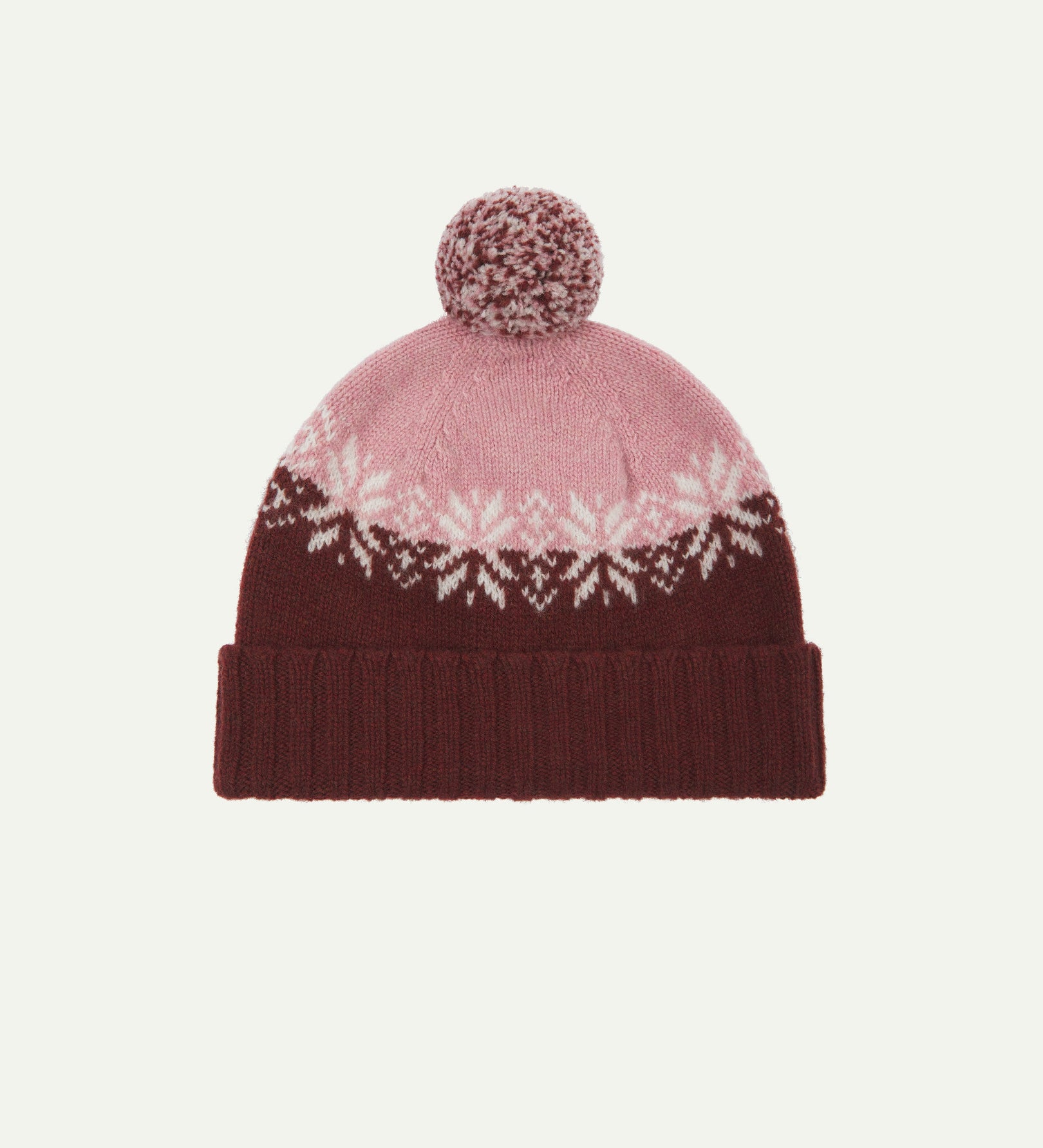 Front view of Uskees 4012 'dusty pink' lambswool snowflake hat, with a clear view of the pink, burgundy and white colourway, snowflake motif and bobble.