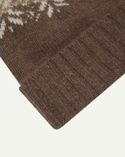 Close-up of the khaki snowflake hat from Uskees, clearly showing the ribbing of the adjustable cuff and texture of the natural Scottish lambswool.