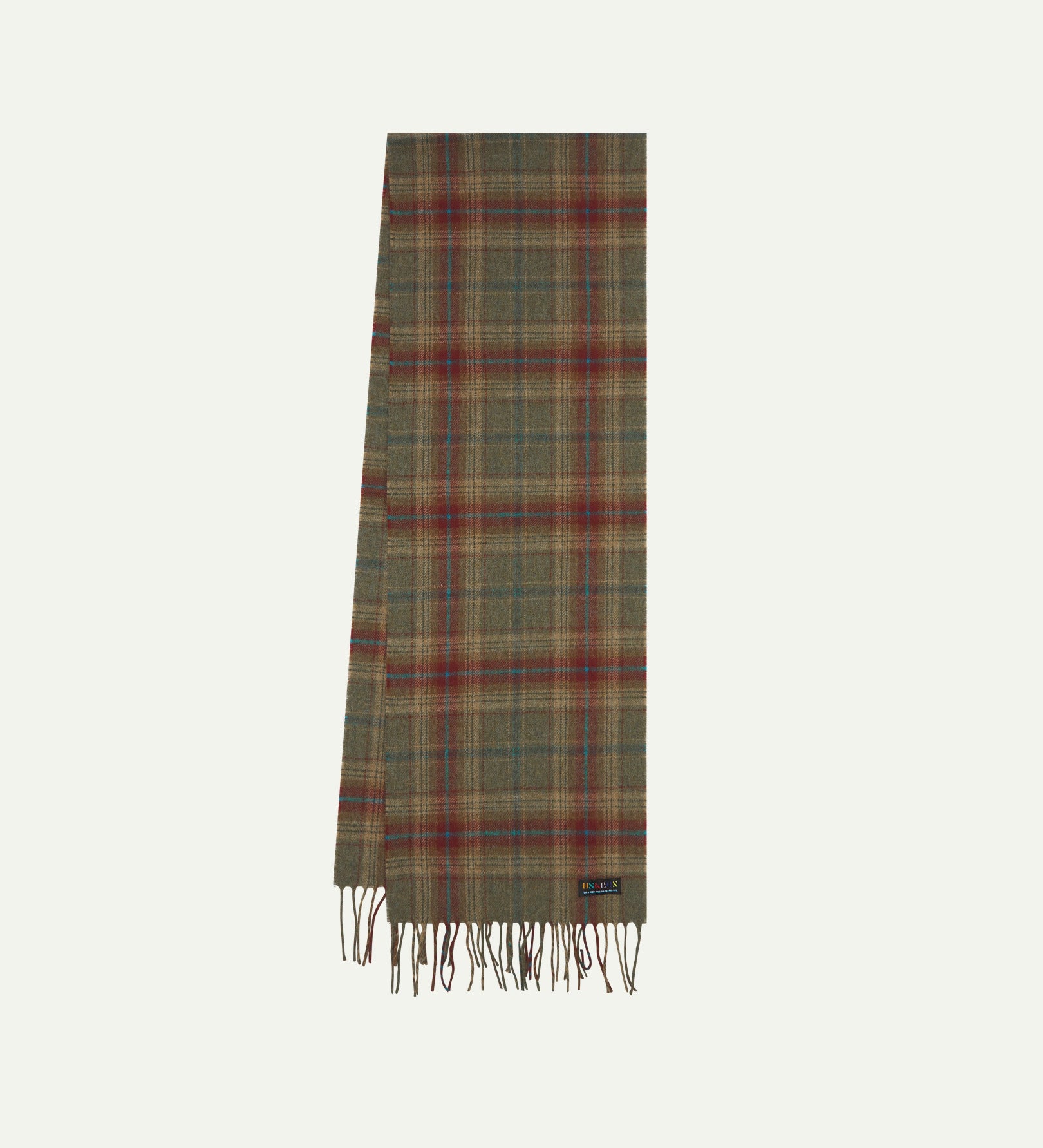 Uskees tartan lambswool scarf presented on a flat white background folded in half showing the green and red pattern and tassels.