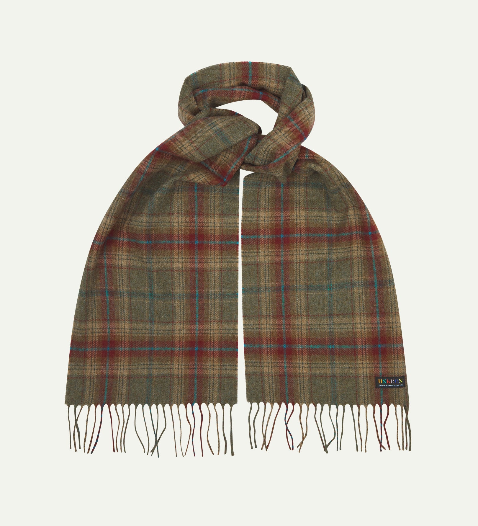 Uskees scarf presented on a flat white surface - tied and showing the green and red check pattern and tassels.