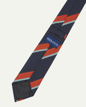 Close-up reverse view of recycled polyester repp tie, showing tricolour stripes, Uskees branding label, tie loop and black lining.