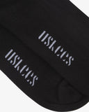The sole of the 4015 black cotton socks with focus on the 'USKEES' branding