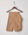 Folded front hanging shot of #5001 Uskees men's organic cotton khaki drawstring trousers.