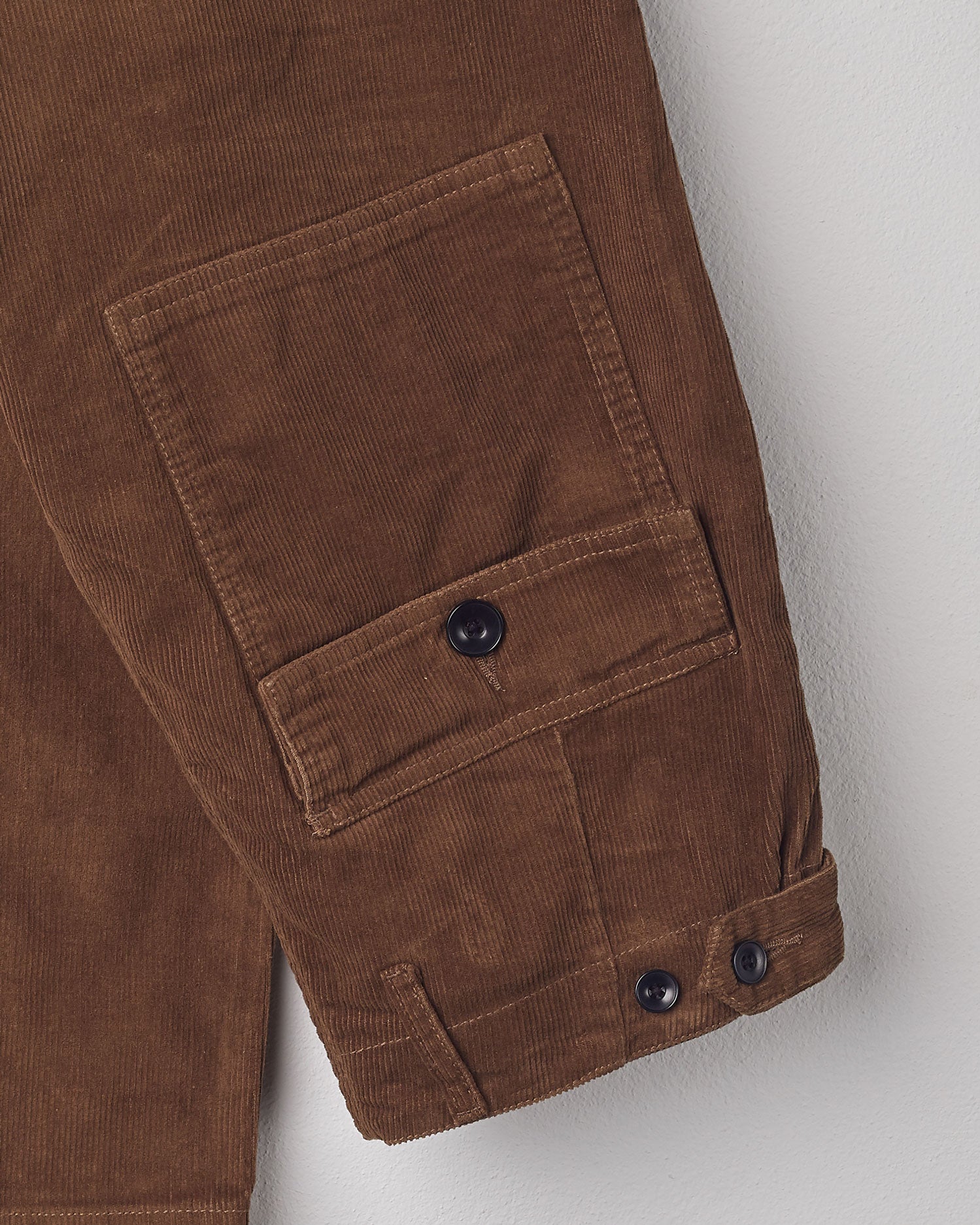 Close-up folded view of #5005 Uskees cord workwear pants in brown showing triple stitching.
