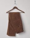 Folded hanging shot of #5005 Uskees men's organic cord 'brown' casual trousers.