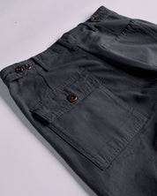 Close-up and angled reverse view of Uskees charcoal-grey cotton work pants with focus on left rear pocket, belt loops and triple stitching. Discontinued colour.