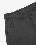Close up of waist area of drill workwear pants in charcoal-grey. Clear view of front pocket, Corozo button fastening, and organic cotton drill weave.