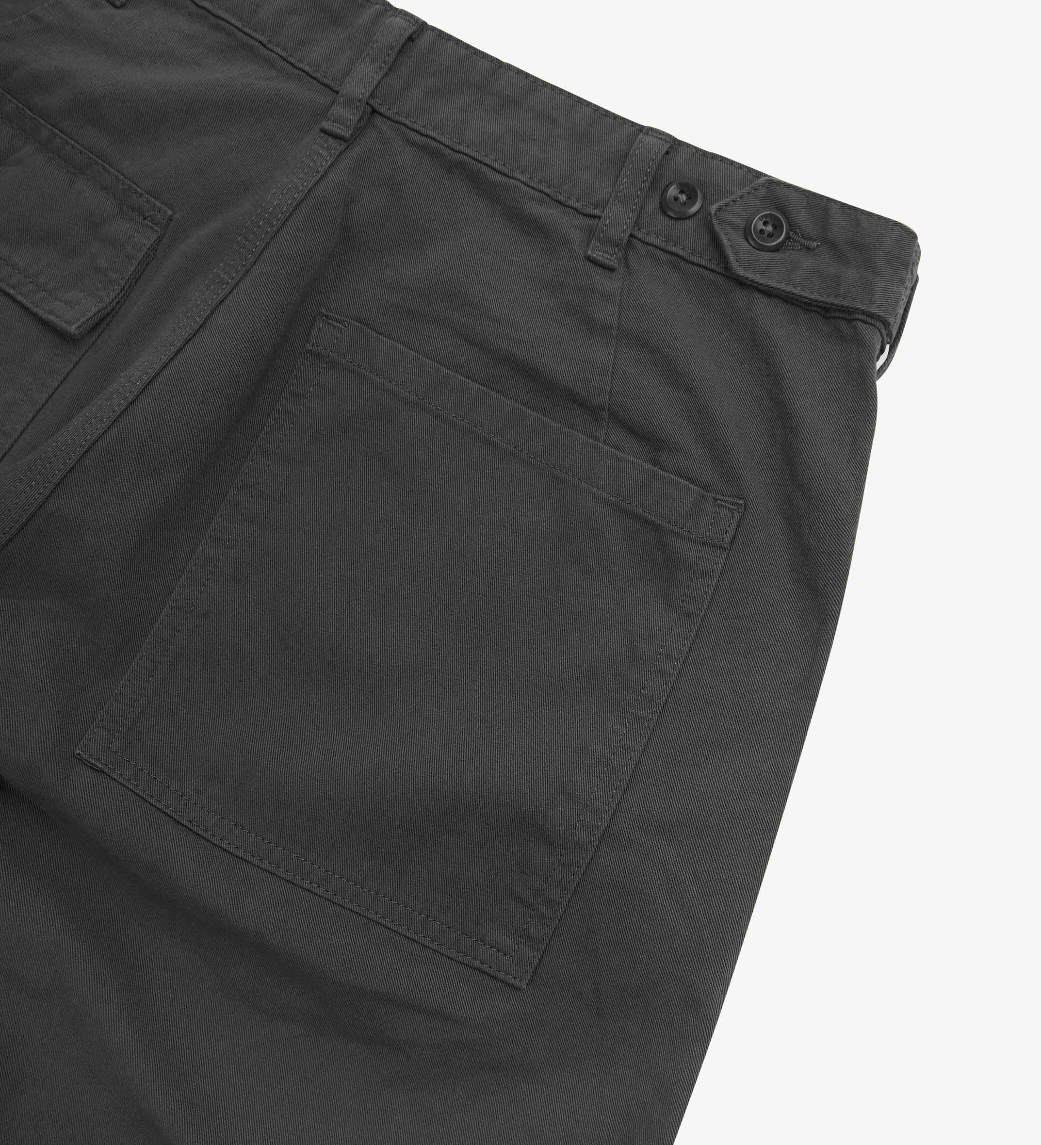 Close up back shot of Uskees 5005 twill workwear pants in charcoal-grey with focus on back pocket, adjustable waistband secured with Corozo button and belt loops.