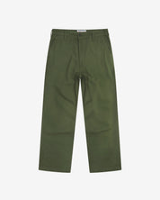 Full-length front view of Uskees twill workwear pants in coriander-green. Showing Corozo button fastening and tapered leg fit.