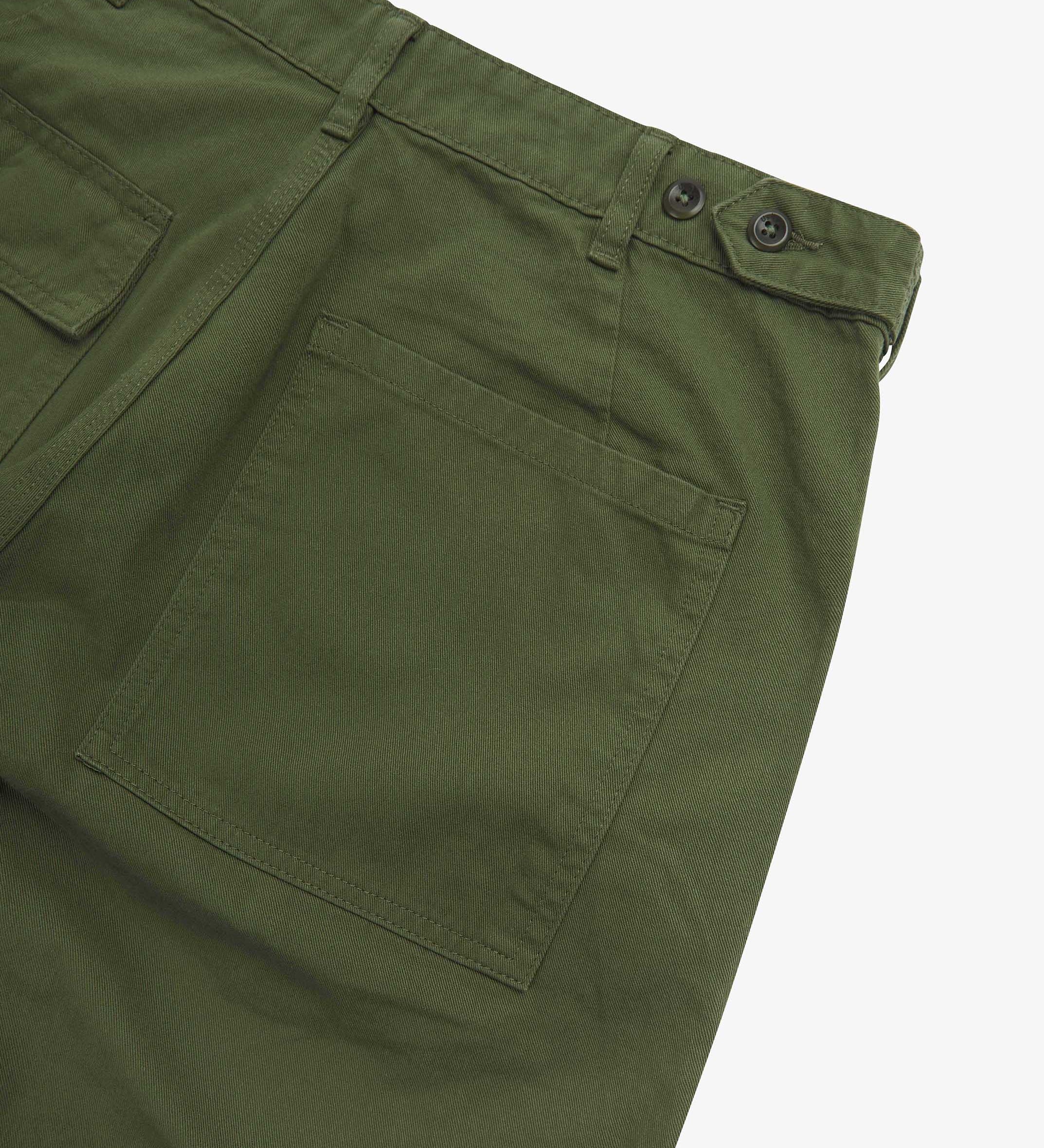 Close up back shot of Uskees 5005 twill workwear pants in coriander-green with focus on back pocket, adjustable waistband secured with Corozo button and belt loops.