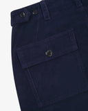 Close-up reverse view of Uskees deep indigo corduroy work pants with focus on left rear flap pocket, belt loops and adjustable button waist.