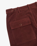 Close-up of Uskees deep wine berry corduroy trousers showing pocket and button details on a white background.