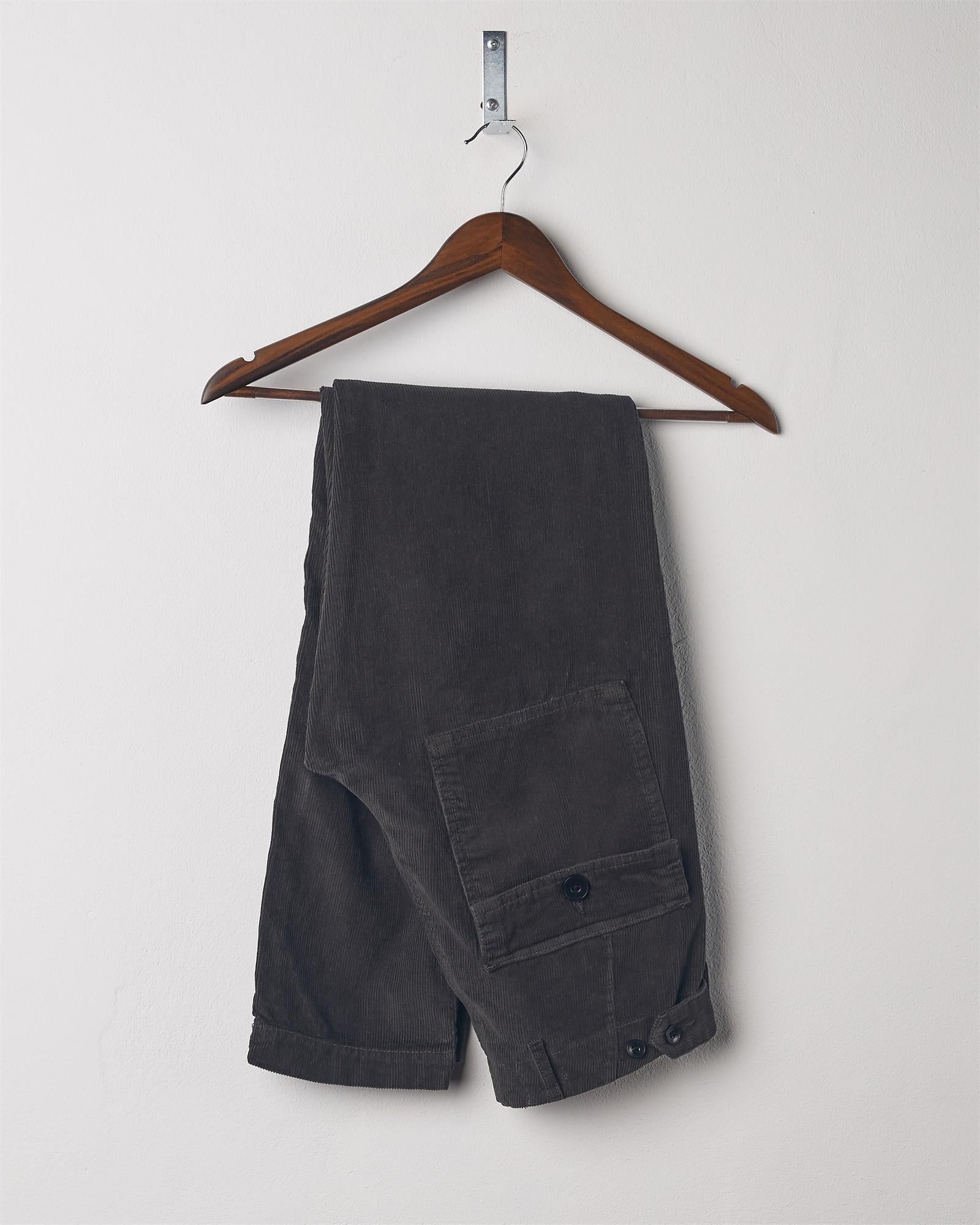 Folded hanging shot of #5005 Uskees men's organic cord 'faded black' casual trousers.