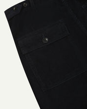 Close-up reverse view of Uskees midnight blue corduroy work pants with focus on left rear pocket, belt loops, triple stitching and adjustable button waist.