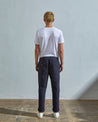 Full length front-view of model wearing midnight blue 5005 work-style trousers with view of YKK zip fly and Corozo buttons.