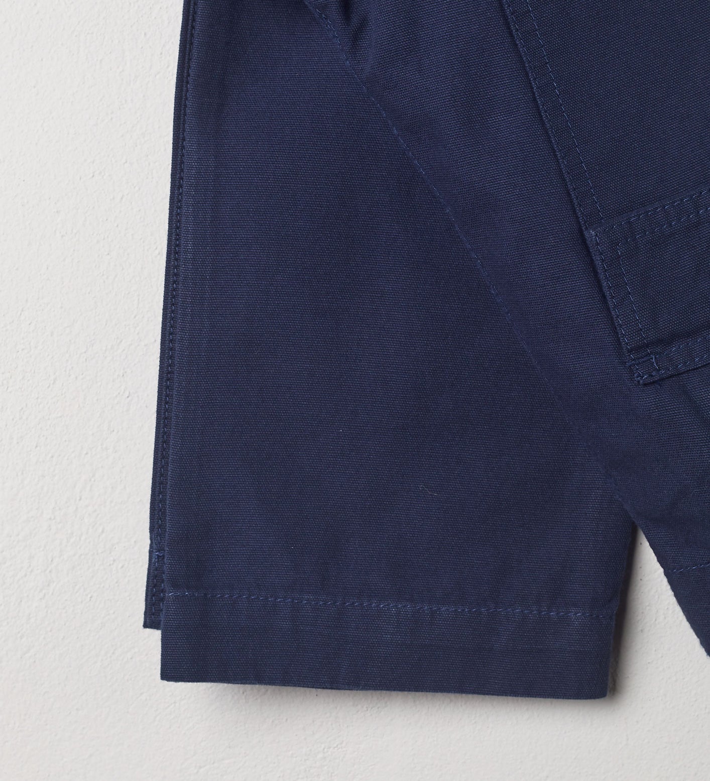 Close-up view of #5005 Uskees organic cotton workwear pants in navy showing triple stitching.