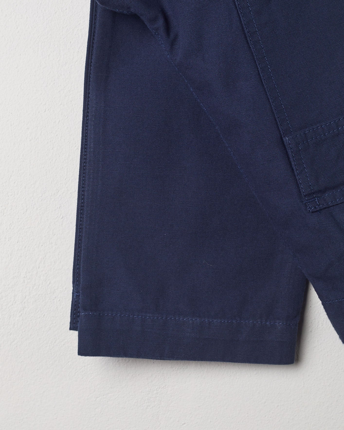 Close-up view of #5005 Uskees organic cotton workwear pants in navy showing triple stitching.