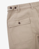 Close up shot of Uskees oatmeal cotton drill trousers for men showing the buttoned back pocket , belt loops and waist adjuster buttons.
