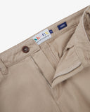 Close up shot of Uskees oatmeal cotton drill trousers for men showing the waistband, fly zip and brand label.