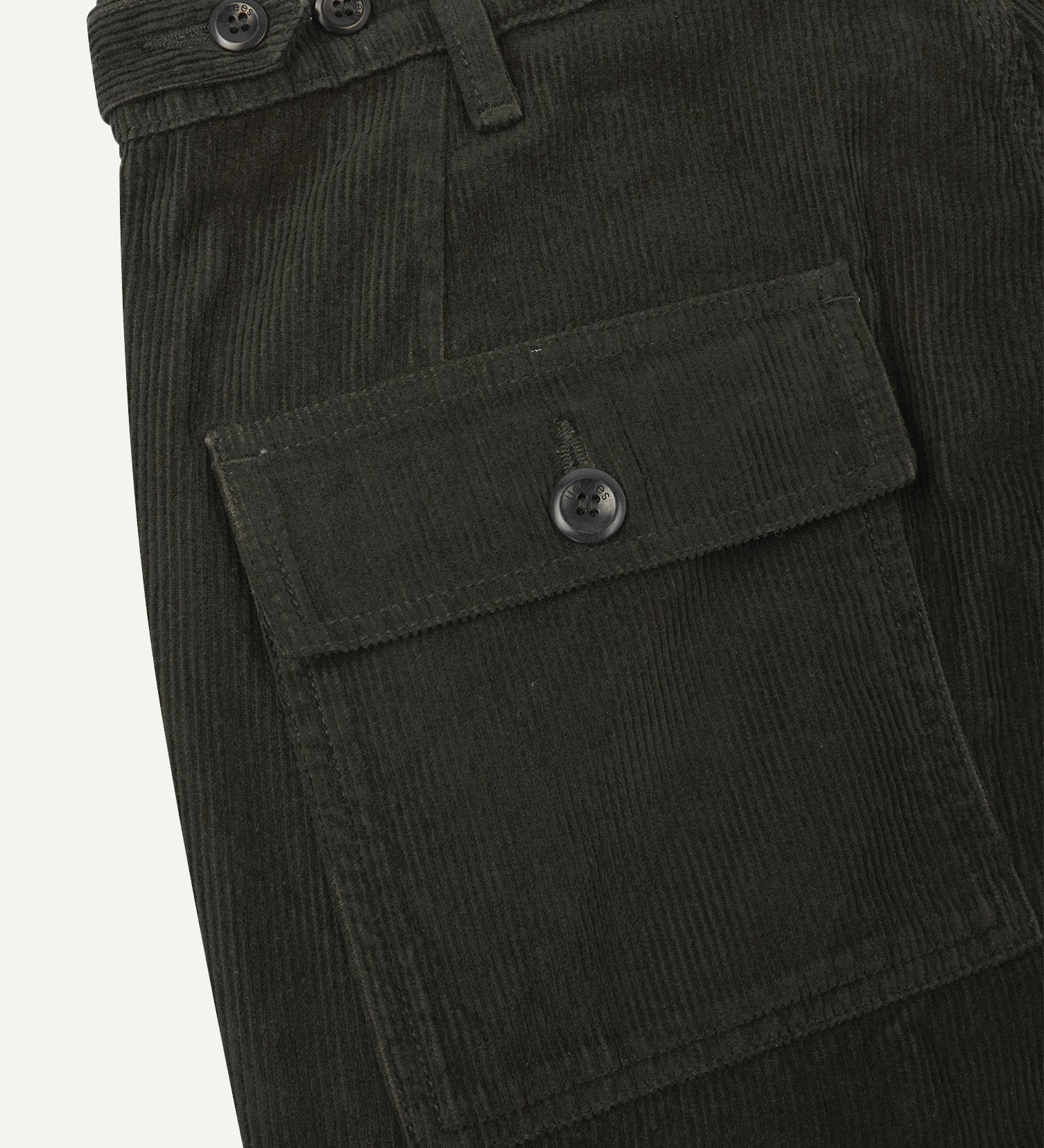 Close-up reverse view of Uskees green-brown (seaweed) corduroy work pants with focus on left rear flap pocket, belt loops and adjustable button waist.