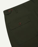 Close-up reverse view of Uskees vine green cotton work pants with focus on left rear pocket, belt loops, triple stitching and adjustable button waist.