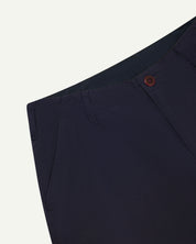 Front close-up view of uskees #5005 men's trousers in dark blue  showing front pocket, belt loops and corozo button fastening