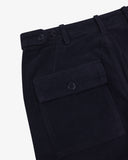 Close-up of Uskees dark blue cord pants showing the buttoned back wallet pocket and waist adjusting buttons on a light gray background.