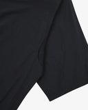 Front close up view of an Uskees black short-sleeve shirt showing the underarm mesh vent.