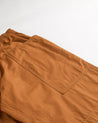 Close angled view of the right pocket and stitching of the 160gsm organic pale brown cotton pants.