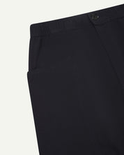 Close angled view of the elasticated waist and corozo button fastening and pockets of the midnight blue green 5011 Uskees pants.