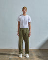 Full length front-view of model wearing olive light 160gsm cotton 5011 trousers with view of deep pockets and paired with plain white t-shirt.