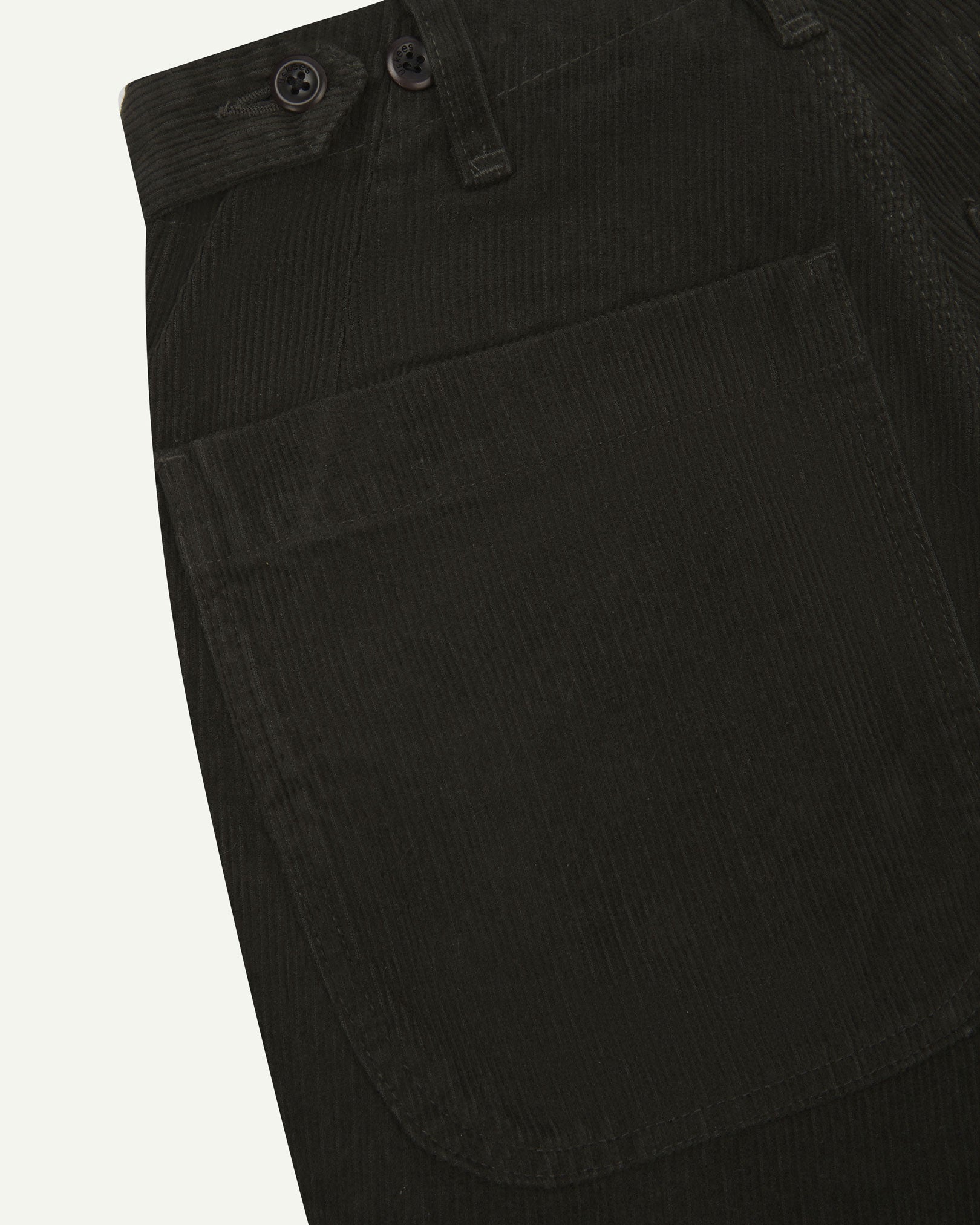 Close up back view of Uskees 5012 corduroy trousers showing back pockets, adjustable waistband and corozo buttons.