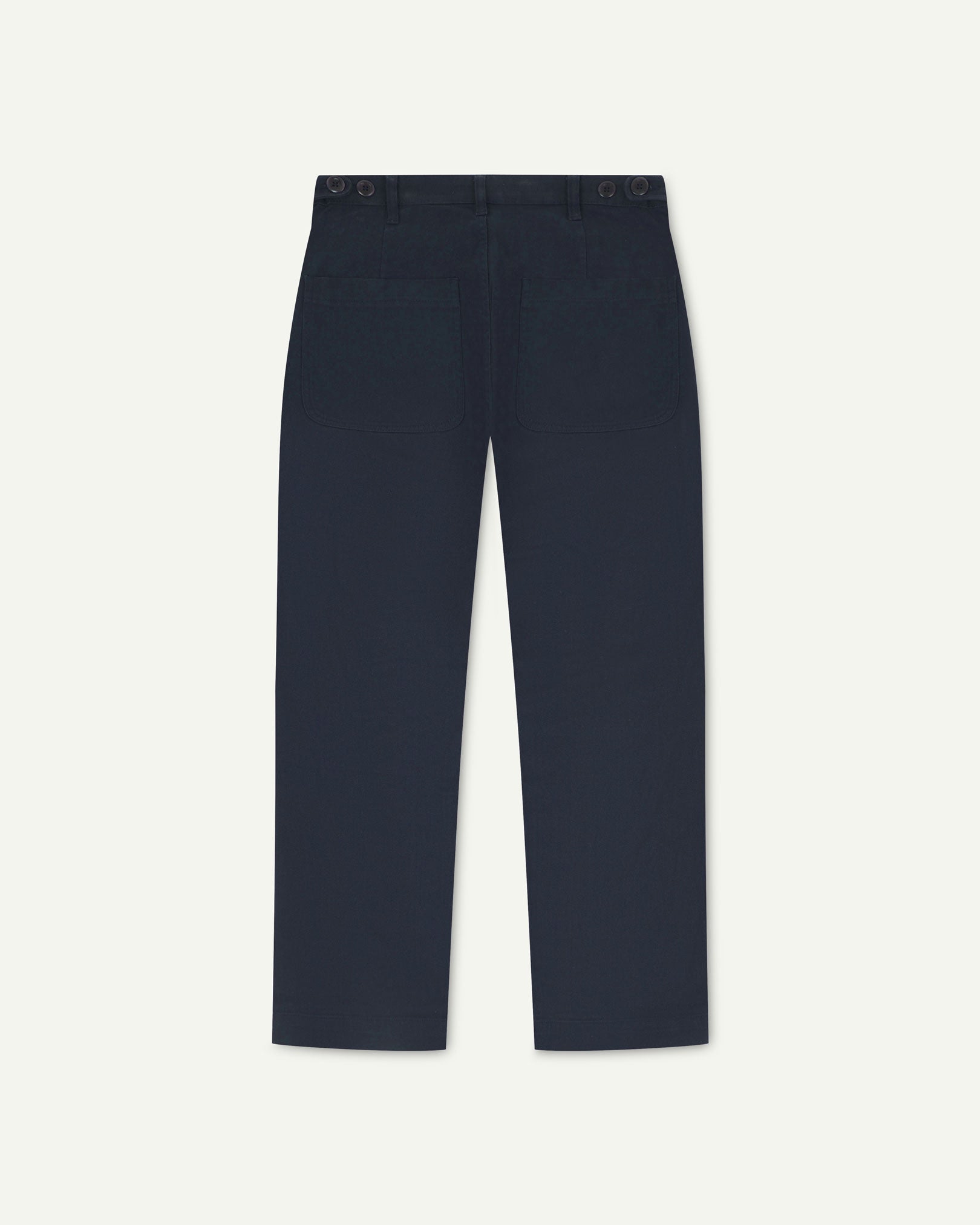 Back flat view of 5013 Uskees drill straight leg pants in dark blue, with focus on on rear pockets and adjustable waistband with corozo buttons.