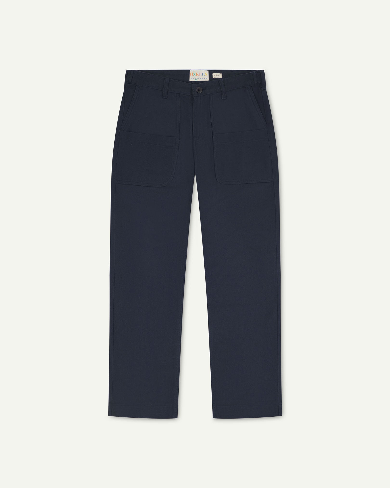 Front flat view of 5013 Uskees drill straight leg pants in dark blue, with focus on front pockets, layered pockets, belt loops and Uskees branding label.